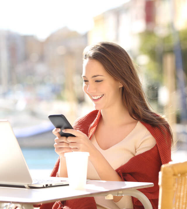 business woman using laptop and mobile phone for files
