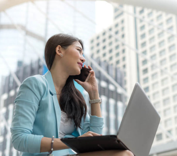 business woman using laptop and mobile phone for files